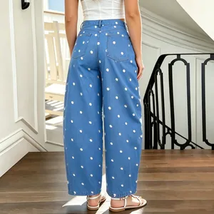 Back view of women's loose curved denim jeans featuring white polka dot pattern
