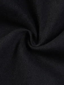 Macro detail of high-quality black stretch denim fabric showing its premium texture.