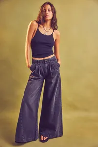 Close-up showing the relaxed fit and washed texture of high-waisted wide-leg jeans
