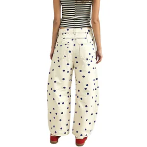 Back view of cream wide-leg barrel jeans with blue polka dots and low-waist design