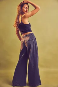 Back view of stylish high waist wide-leg denim pants for women in street style