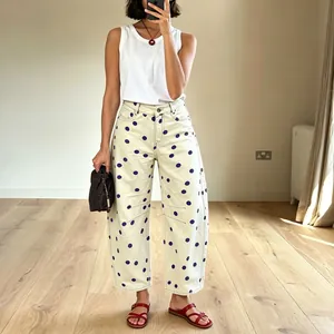Detailed view of women's polka dot curved jeans with loose casual fit in cream white