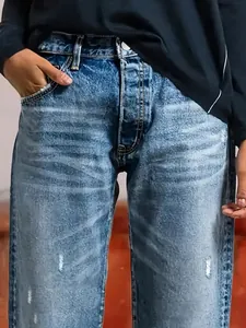 Women's loose fit straight-leg denim jeans with vintage wash and distressed details