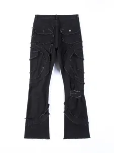 Back view of black distressed flared jeans with frayed seams and flap pockets