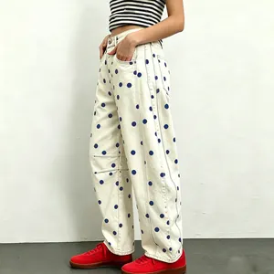 Detailed side view of women's loose-fit polka dot jeans with a trendy wide-leg silhouette