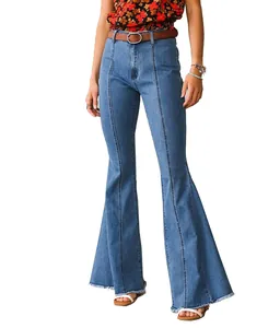 Detail view of high-waisted blue flared jeans with vertical seams and frayed hemline