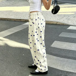 Detailed macro view of baggy polka dot jeans styled in a chic urban street setting
