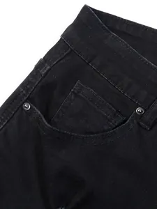 Detail shot of black stretch denim jeans showing front pocket and fabric texture
