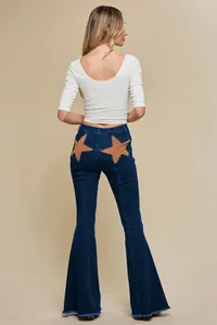 Back view of flare jeans featuring distinctive brown star-shaped patches on pockets.