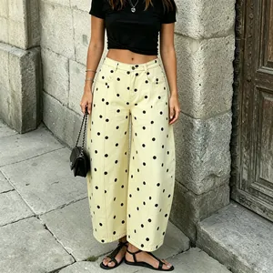 Chic cream-colored wide-leg denim pants with black polka dots and a relaxed curved fit