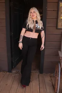 Women's black high-waisted flare jeans with slim fit and elastic stretch fabric.