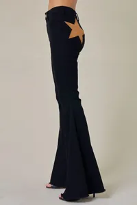 Detail view of high-waisted black flare jeans with side star-shaped cut-out design