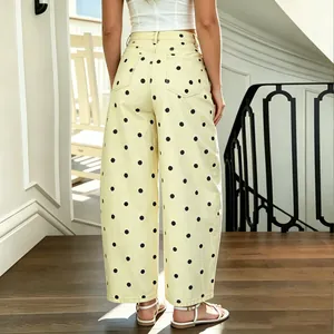 Detailed back view of yellow polka dot baggy banana jeans on a model in a sunlit room