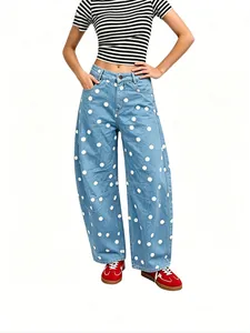 Stylish women's loose-fit barrel jeans featuring white polka dots on light blue denim fabric