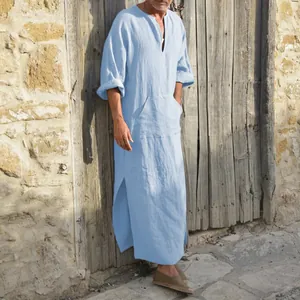 Detailed view of a light blue men's cotton linen kaftan robe in a natural outdoor setting