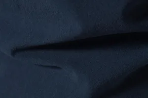 Macro detail of navy blue breathable cotton linen fabric texture for men's casual wear.