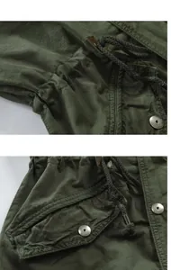 Close-up detail of army green hooded jacket showing drawstring and metal buttons
