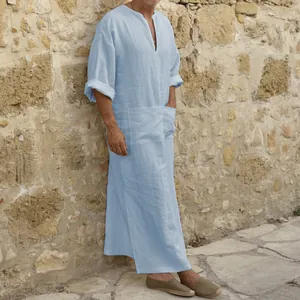 Detailed side view of a stylish men's light blue long linen kaftan robe with side pockets