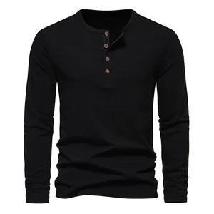 Detail view of a black men's Henley shirt featuring a four-button placket and round neck
