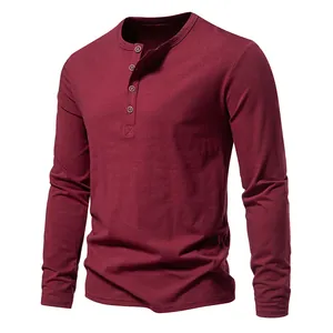 Close-up of a men's maroon Henley long sleeve T-shirt with a four-button placket detail.