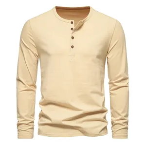 Detailed view of a classic beige men's long-sleeved Henley shirt with four-button placket.