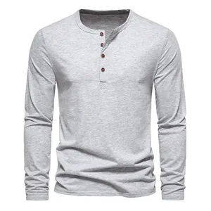 Detailed macro shot of men's grey long-sleeved Henley T-shirt with four-button placket