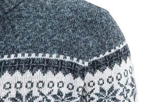 Close-up macro detail of men's grey and white knit sweater with snowflake pattern