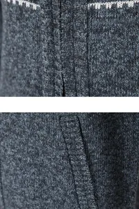 Macro detail showing the high-quality thick knit texture and pocket of a men's winter cardigan.