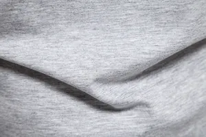 Close-up detail of soft grey heather knit fabric for men's casual Henley T-shirt