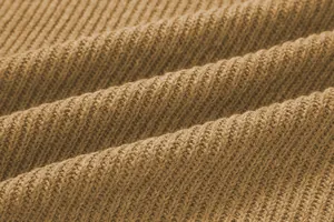 Macro view of high-quality brown ribbed knit fabric texture for men's stylish sweater.