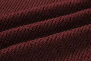 Macro close-up showing the high-quality burgundy ribbed knit fabric texture of the sweater