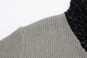 Close-up detail of grey ribbed knit shoulder and black shawl collar seam