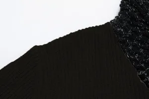 Macro detail of men's slim-fit patchwork sweater with black ribbed knit texture