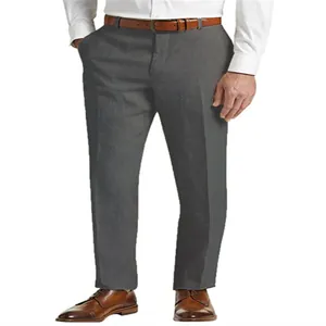 Detail shot of grey linen trousers paired with brown leather shoes and belt.