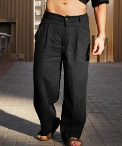 Close-up detail of men's black linen wide-leg pleated trousers in natural sunlight
