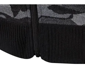 Detailed view of the zipper and ribbed hem on a men's camouflage knitted cardigan jacket.