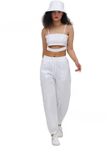 Full body view of a white shiny leather performance outfit with a bucket hat and joggers.