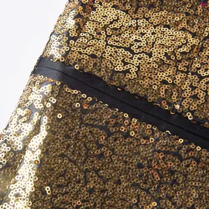 Gedetailleerd overzicht van gouden pailletten op een zwarte herenblazer voor optredens