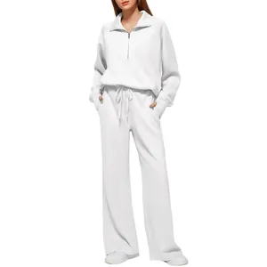 Women's elegant white two-piece sweatsuit set with half-zip hoodie and wide-leg pants