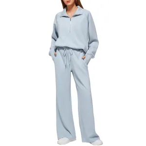 Light blue women's two-piece loungewear set with zip sweatshirt and wide-leg pants.