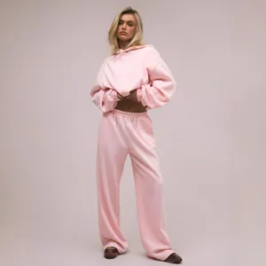 Damen Set aus pinkfarbenem Oversized-Kapuzenpullover und lässiger Jogginghose mit weitem Bein
