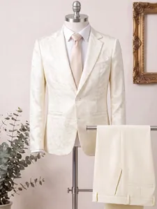 Detail of ivory floral jacquard slim fit suit jacket and matching trousers for groom