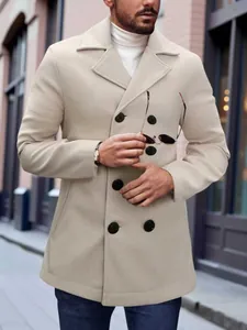 Outdoor street shot of a man wearing a beige wool coat with a white turtleneck