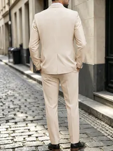Back view of a premium slim fit beige gentleman suit set against a cobblestone street