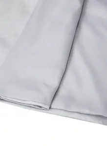Macro view of smooth silver fabric texture on a modern business suit jacket