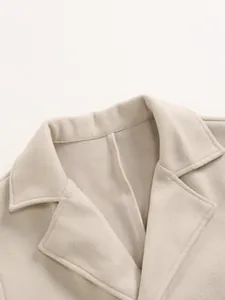 Close-up detail shot of a men's beige wool blend coat collar showing high-quality stitching
