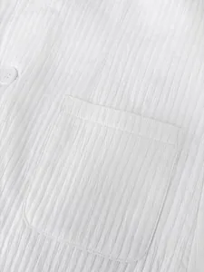 Macro detail shot of white crinkle textured fabric on a men's business suit jacket pocket.