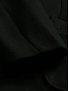 Close-up detail of high-quality black wool fabric on a men's winter overcoat