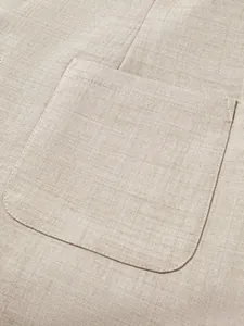 Macro view of a beige linen-textured chest pocket on a classic men's business suit