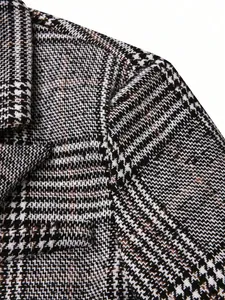 Detailed macro view showing the high-quality plaid fabric texture of a men's blazer jacket